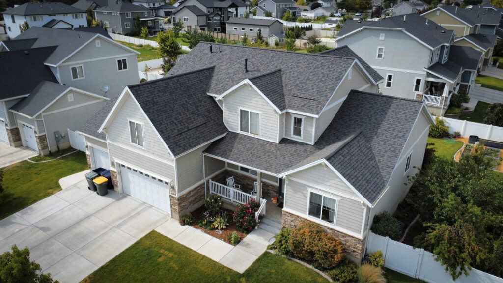 Roofing Contractor checking flashing and shingles on a Daniel - UT home before winter weather