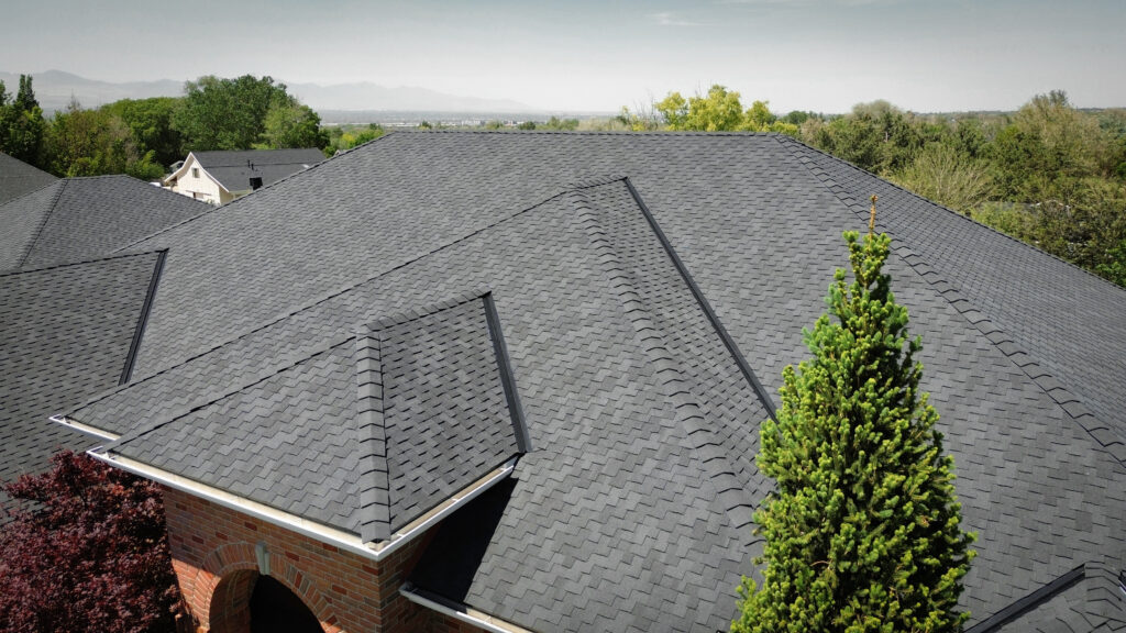 Roofing Contractor reviewing vent flashing on a Clearfield - UT home during an exterior inspection, Roofing Contractor reviewing ice-related roof damage on a Heber City - UT mountain home