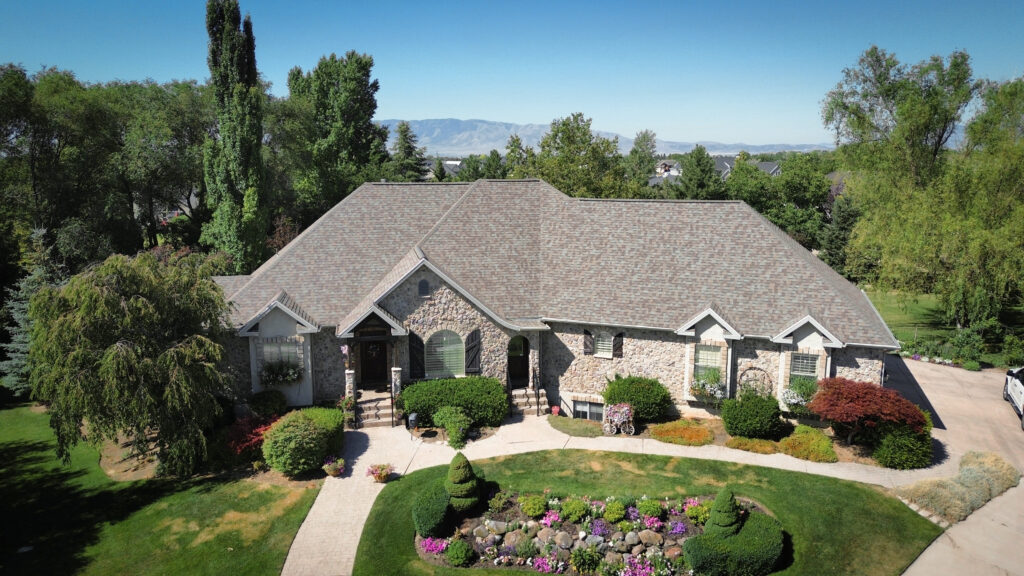 Roofing Contractor in Hideout - UT inspecting mountain home shingles after a recent storm