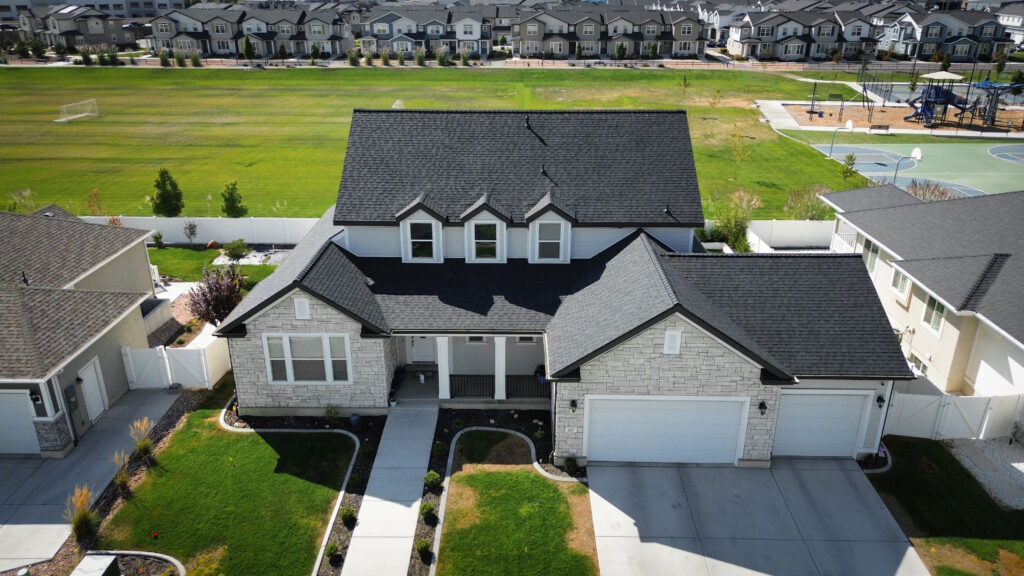 Roofing Contractor measuring roof sections on a Kaysville - UT home before repair planning