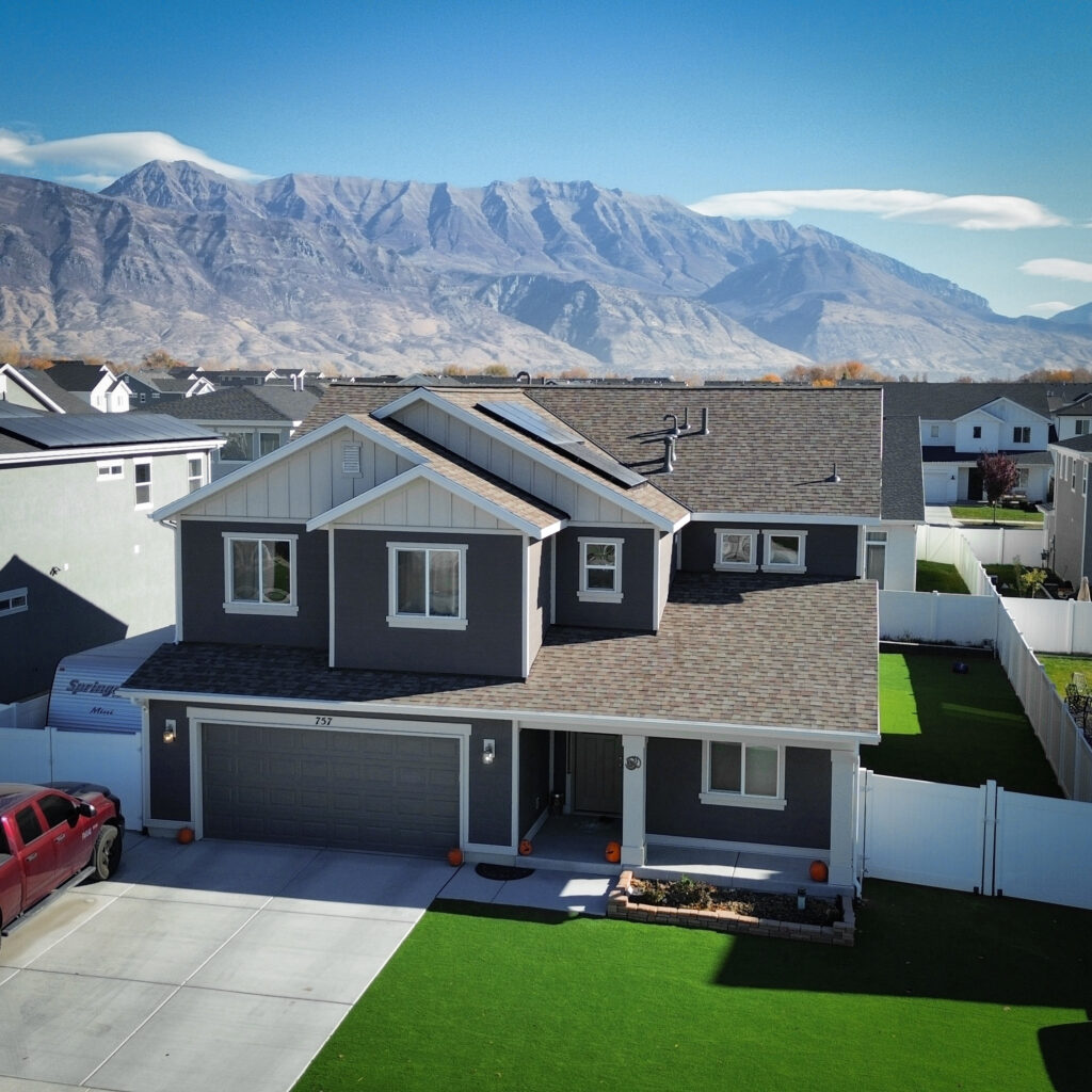 Roof Repair in Bountiful - UT as a crew replaces lifted shingles beside a roof vent