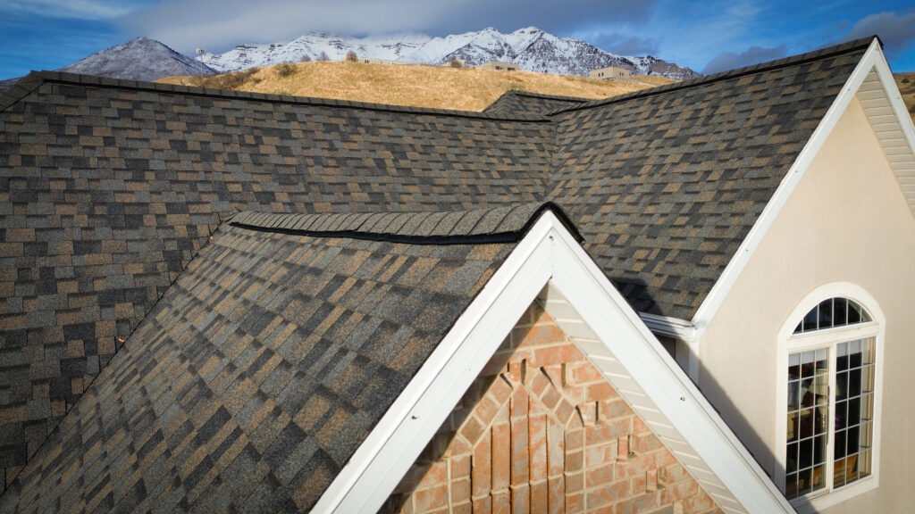 Roofing Contractor checking underlayment exposure on a Midway - UT home during a cold-weather inspection