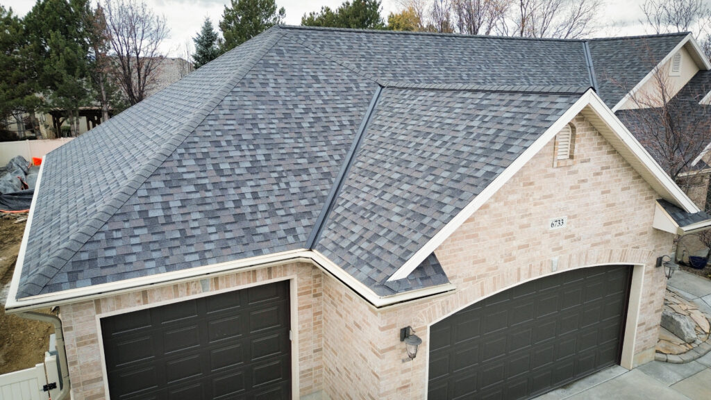 Roofing Contractor in Saratoga Springs - UT inspecting shingles and flashing on a sloped residential roof, Roofing Contractor in Davis County - UT inspecting storm-worn shingles on a sloped residential roof, Roofing Contractor in Davis County - UT inspecting storm-worn shingles on a sloped residential roof, Roof repair specialist in Bountiful - UT securing flashing around a chimney after wind damage, Roof Repair in Syracuse - UT underway as a roofer seals flashing near a roof valley